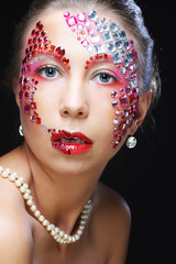 Closeup portrait of woman with artistic make-up. 
