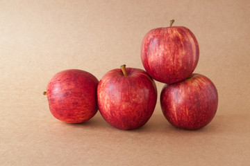 group of red apples on brown paper background 