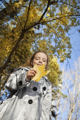 happy girl in leaves autumn