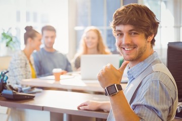 Portrait of smiling young businessman with colleagues 