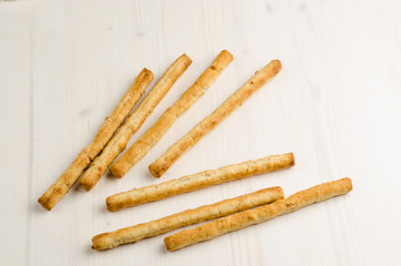 rustic breadsticks on wood table, close up, background