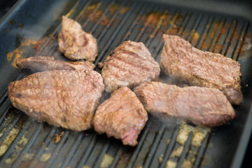 cooking steaks on a hot grill