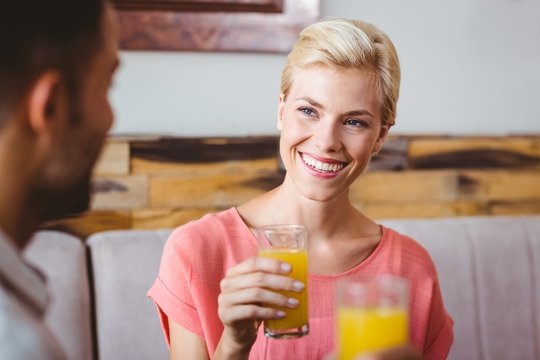 Pretty blonde holding a glass of orange juice 
