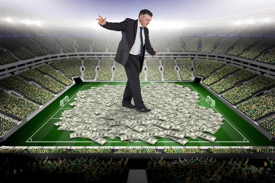 Composite image of mature businessman doing a balancing act