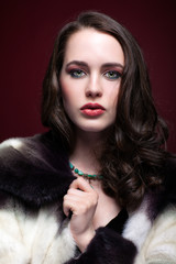 Young beautiful woman in fur coat and with green pistachio colou