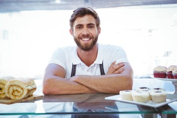  Smiling worker posing behind the counter