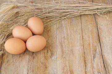 Chicken brown eggs on wooden background