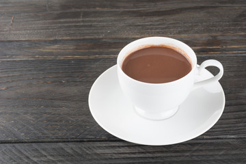 a cup of chocolate on wood table