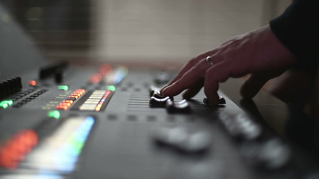 Man mixing sound at professional sound mixer.
