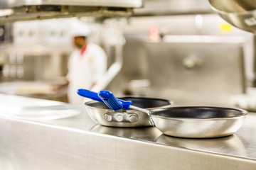 Commercial Pans with Chef in Background