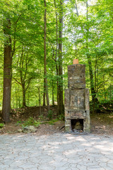 Stone Fireplace in Green Forest
