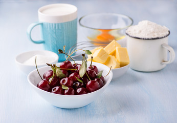 Cup of flour, butter, cherry, egg and milk