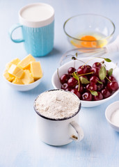 Cup of flour, butter, cherry, egg and milk