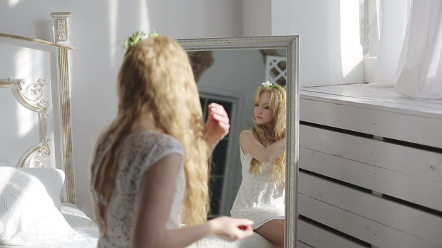 Young woman hair in front of the mirror
