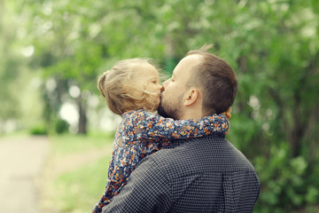 Dad walks with her daughter in the park