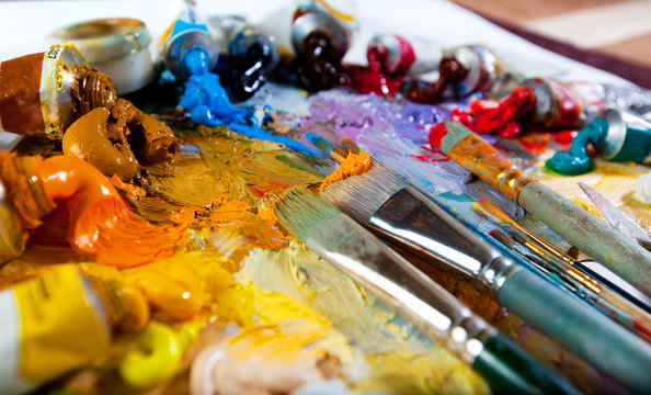 Art palette with oil paints and brushes. theme with paint brushes and palette