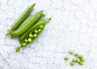 Green peas on the vintage linen background