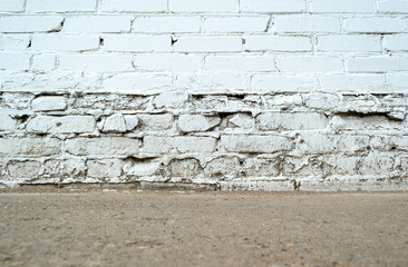 Empty grunge brick wall with ground floor