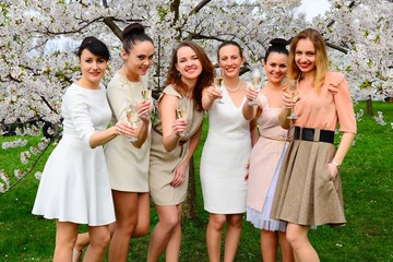 Girls with champagne celebrating in sakura's garden.