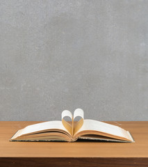pages of a book curved into a heart shape