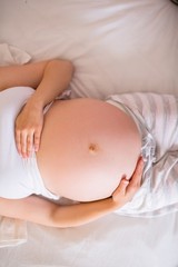 Fototapeta na wymiar Close up view of pregnant woman belly 