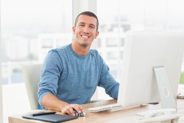 Young creative businessman working on the computer