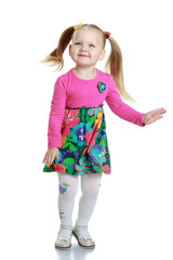 Lovely cheerful little girl with long blonde tails waving his ha