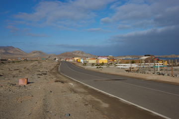 Route 5 running along the coast past the small village of Puerto Flamenco in the Atacama desert in Chile