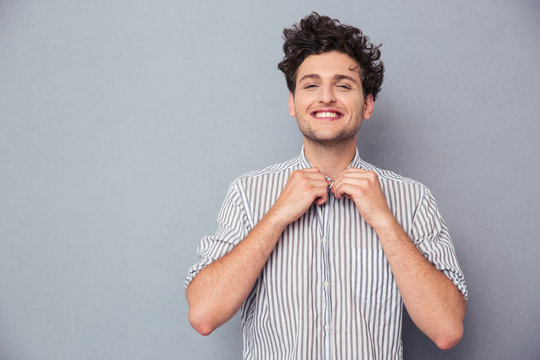 Happy Man Buttoning Shirt