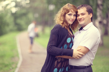 Fototapeta premium Young couple hugging in the park summer
