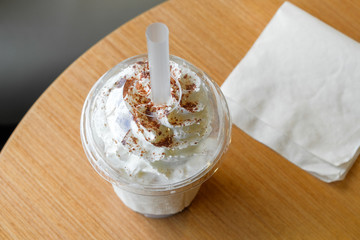 Ice chocolate frappe and whipped cream in the takeaway plastic cup