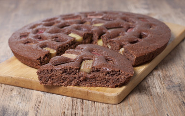 Chocolate cake with rhubarb    on a wooden board