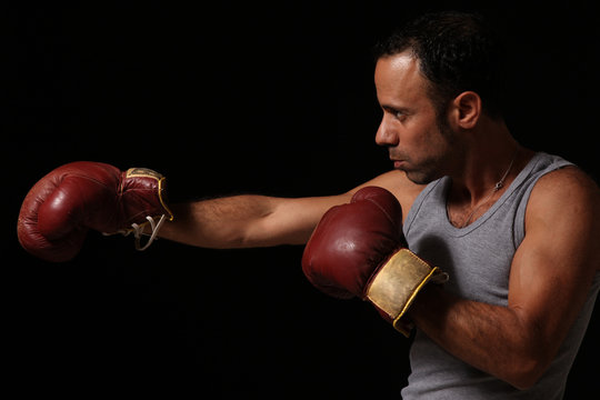 A male boxer wearing gloves. 