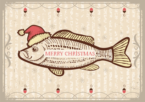 Christmas fish in Santa red hat.Vintage drawing card on old text