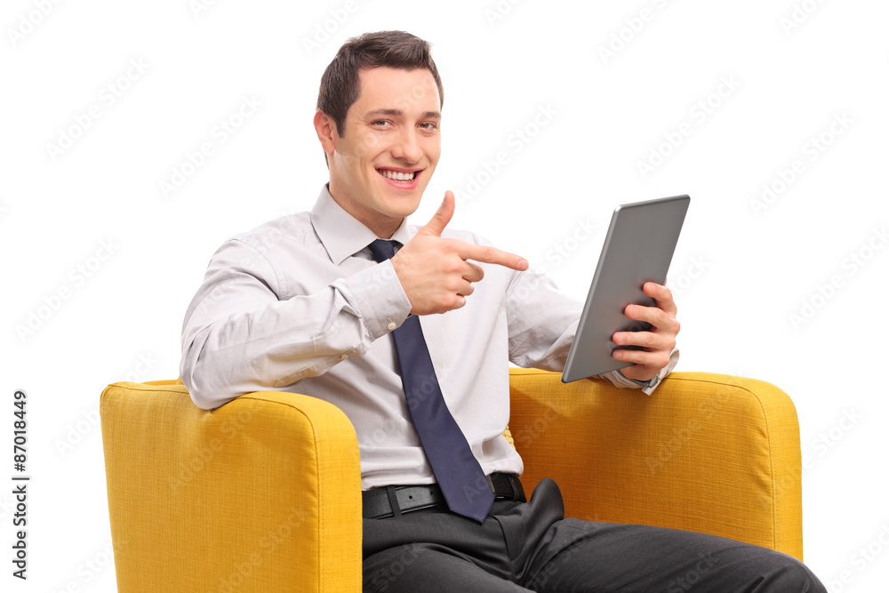 Sticker businessman holding a tablet seated in an armchair