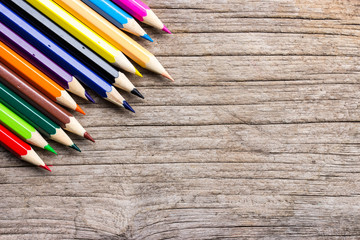 Colorful pencils background on wooden floor