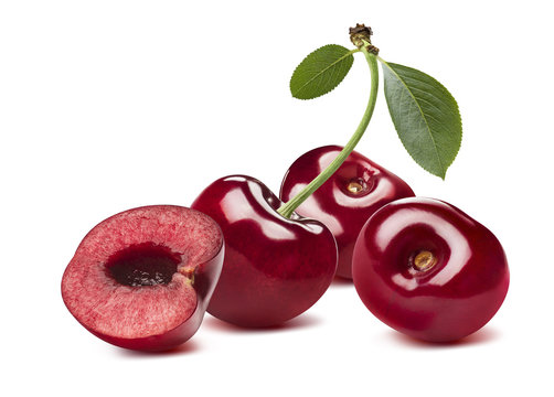 3 sweet cherries and half isolated on white background