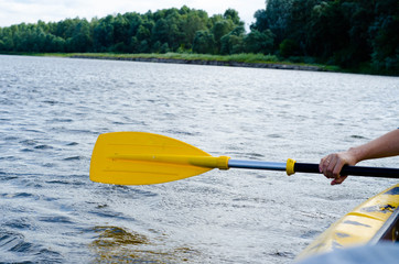 Rowing, holding a kayak paddle