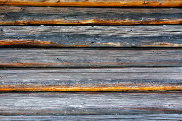 part of the wall made of wooden logs