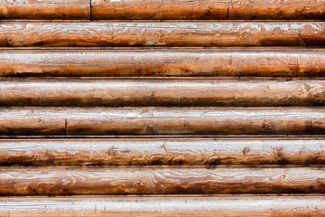 part of the wall made of wooden logs
