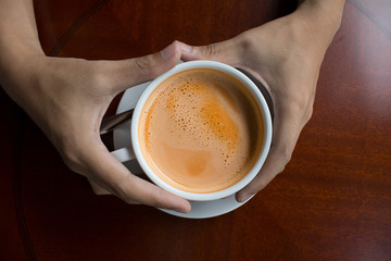 hand holding a cup of coffee hot drink design