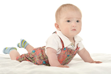 Baby boy crawling on blanket