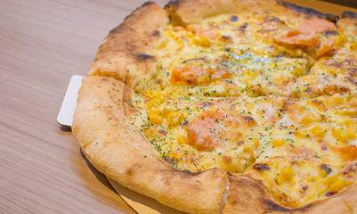 Salmon Pizza on wooden background