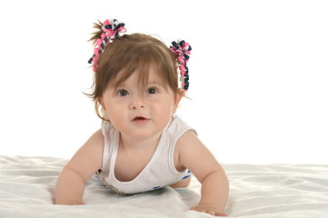 Baby girl lying on  blanket