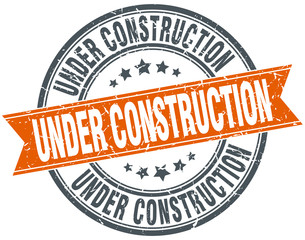 under construction round orange grungy vintage isolated stamp