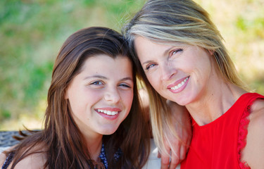 Mother and daughter hugging, smiling and sharing. Mothers day concept. Serenity and tranquility.