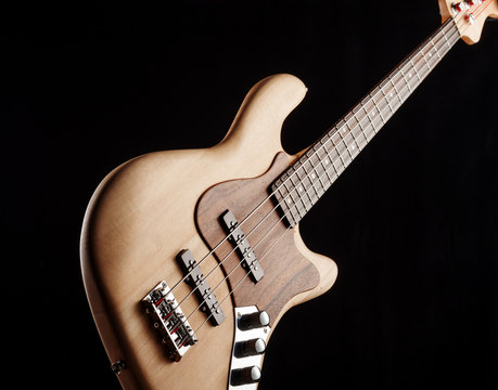 electric bass guitar on black background