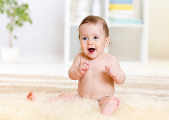 baby sitting on fluffy carpet at home