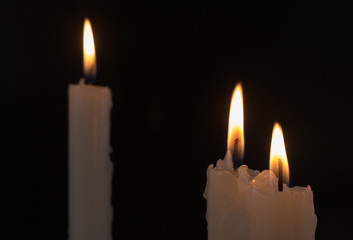 Three White Candles Burning at Night Time