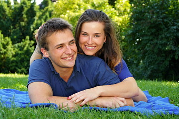 Smiling young girl with his boyfriend outdoor in the nature